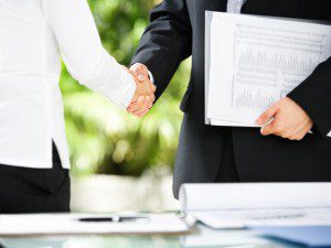 Handshake between businessman and businesswoman